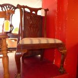 A mahogany Chippendale style side chair with a pierced splat back raised on ball and claw feet