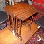 An inlaid mahogany nest of three tables raised on turned stretchered supports