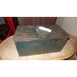 An old green painted metal tool box with fitted interior