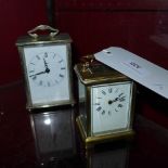 A brass carriage clock and a similar carriage clock