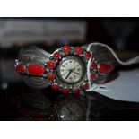 A Native American sterling silver and coral watch bracelet with an inset lyceum watch