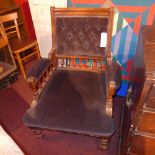 A Victorian mahogany armchair upholstered in buttoned velour on turned supports