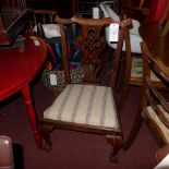 A pair of C19th carved oak elbow chairs with tapestry upholstered drop in seats and raised on