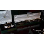 A matching 9ct gold plated necklace and bracelet decorated with elephants, purchased from Fior in