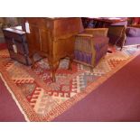 A hand knotted Kazak carpet with red field and repeating motifs in multi border