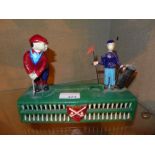 A cold painted golfing money box