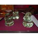 A set of four green glass paperweights