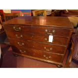 A C18th oak chest fitted two short and three long drawers with heavy brass handles on bun feet