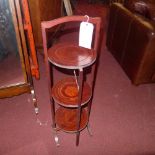 A mahogany three tier folding cake stand