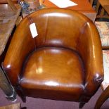 A pair of C20th tub form chairs upholstered in tan hide leather raised on tapering supports