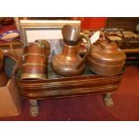 A Victorian copper planter raised on lion paw supports, together with a copper kettle and other