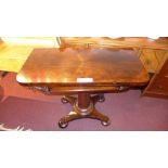 A Victorian rosewood card table raised on faceted column and platform base