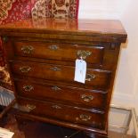 A Georgian style burr walnut and crossbanded banded bachelors chest with foldover top above four