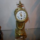 A C19th French brass clock with Roman numerals to the dial and an 8 day movement