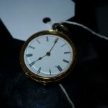 An 18ct gold pocket watch with enamelled Roman numeral dial the case having intricate engraved