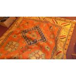 A hand knotted Kazak carpet with red field and repeating motifs in multi border