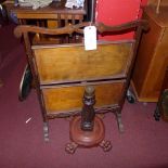 An Edwardian mahogany two tier folding cake stand together with a carved stand raised on lion paw