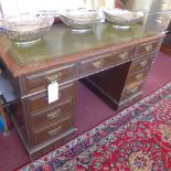 A Victorian oak pedestal desk the tooled leather top above arrangement of nine drawers with brass