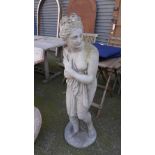 A reconstituted stone garden statue of a