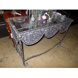 A wrought iron console table with rope t