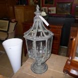 A verdigris candle lantern with five tea light and glass panels