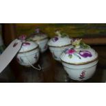 A Meissen set of four porcelain cups and cover with hand painted floral decoration (a/f)