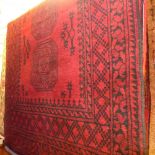 A hand knotted Afghan rug the red field