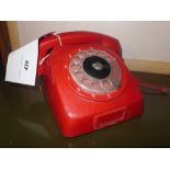 A vintage red plastic telephone
