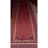 A fine north west Persian Malayer runner 357 cm x 85 cm repeating Heratie motifs on a terracotta