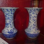 A pair of Japanese blue and white vases with birds in trees