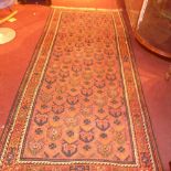 A Persian Kurdish rug the lilac ground with repeating motifs in a triple border