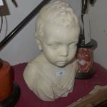 A Victorian carved marble bust of a young boy marked C. E. Ewing Fecit