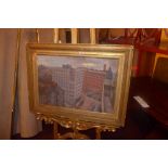 An oil on canvas cityscape in a gilded frame