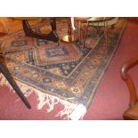 A Persian hand knotted carpet the multicoloured field with repeating geometric diamond motifs in a