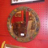 An early C20th mirror the circular plate within carved and painted giltwood frame