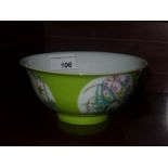 A Chinese green glazed bowl with floral pictoral reserves