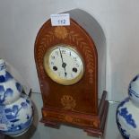 An Edwardian mahogany mantel clock of lancet form with inlaid shell and flowerhead decoration