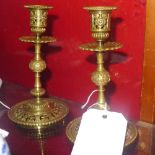 A pair of Victorian brass candlesticks with pierced decoration all over