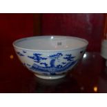 A Chinese blue and white bowl decorated with dragons and pheonix