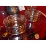 A pair of silver plated and rosewood wine coasters with pierced decoration