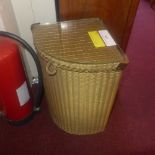 A Lloyd loom wicker laundry basket with plate glass top