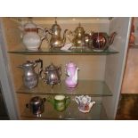A collection of silver plated metalware, ceramic teapots and jugs