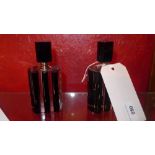A pair of Art Deco style black and clear glass scent bottles with stoppers