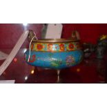 A Chinese cloissone bronze incense burner brightly coloured and raised on three feet