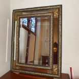 A C19th Continental wall mirror the rectangular bevelled plate within mirrored cushion border and