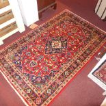 Two fine indentical central Persian Kashan rugs, 150cm x 100cm and 143cm x 95cm, central floral