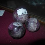 Three coloured crystal balls of graduated size