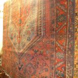 A fine North West Persian Zanjan rug 255 x 137 cm repeating petal and animal motifs on a rouge field