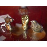A group of three brass vesta cases in the form of a closed fist a bird and a horses head