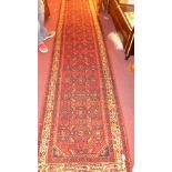 A fine north west Persian Malayer runner 357 cm x 85 cm repeating Heratie motifs on a terracotta